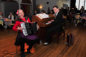 Musicians Bill and Sian playing musical instruments